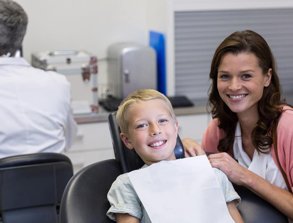 A pediatric dentist caring for a child patient