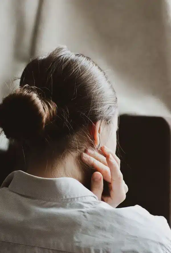 A woman with neck pain looking for a TMJ dentist